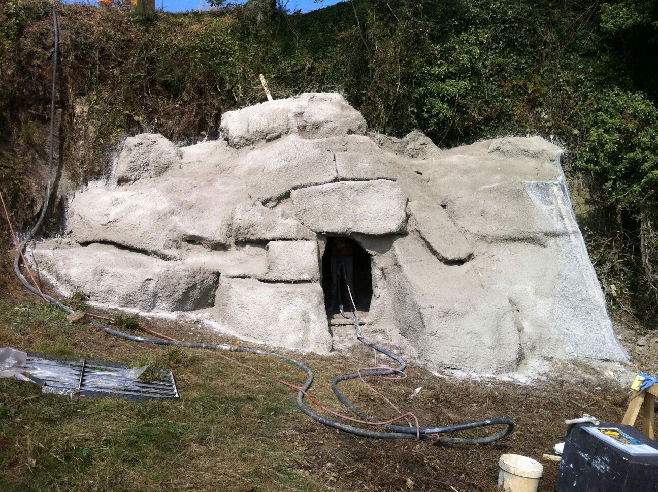 Una gran roca en medio de un campo con un agujero en ella.
