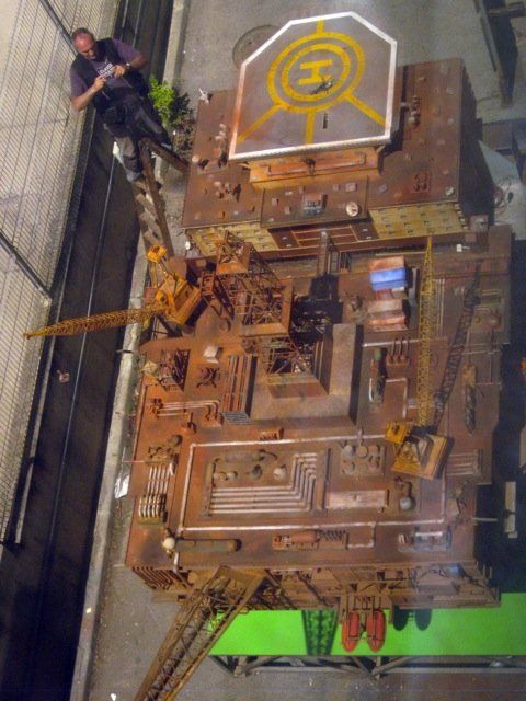 Una vista aérea de un modelo de una ciudad con un helicóptero encima.