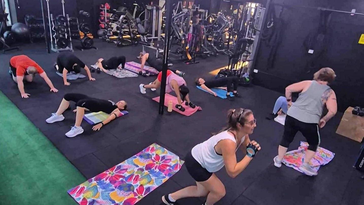 A Bunch Of Kettlebells On A Rack In A Gym — 360 Fitness Group in Gordonvale, QLD