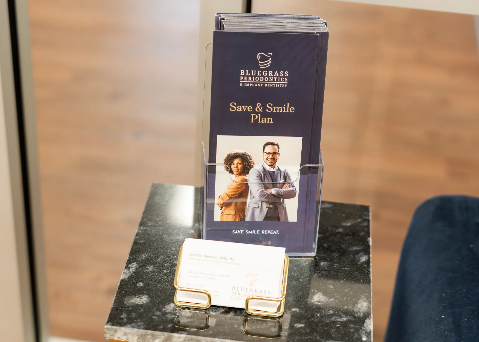 Display stand with blue box featuring people, business card holder.