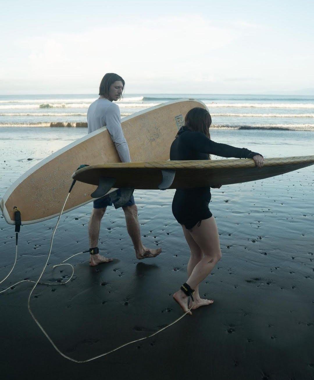 me walking out to the beach with a surfboard