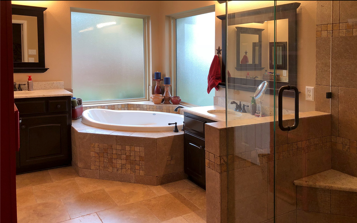 A bathroom with a large tub and a walk in shower