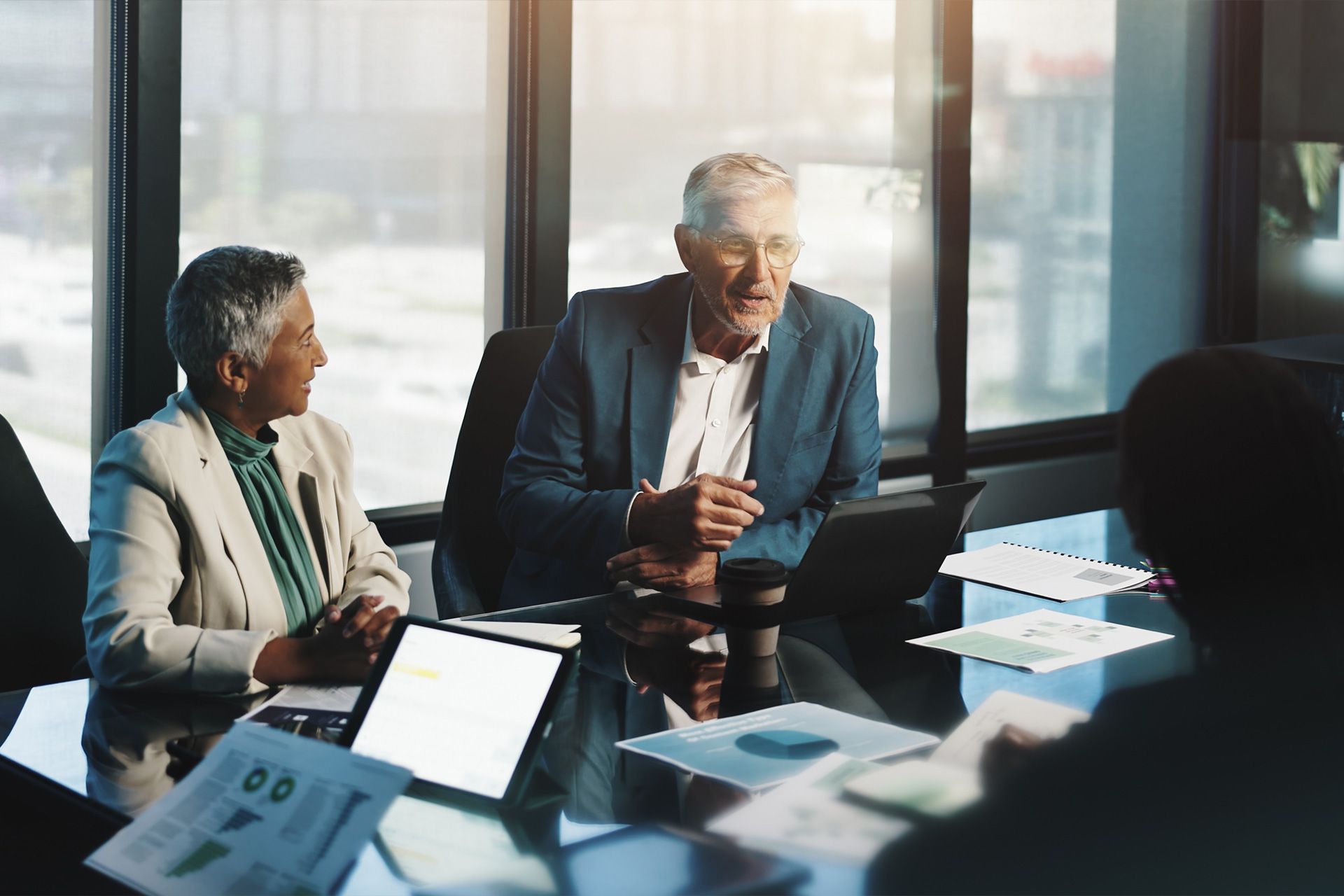 A man is working on a heat pump outside of a house.
