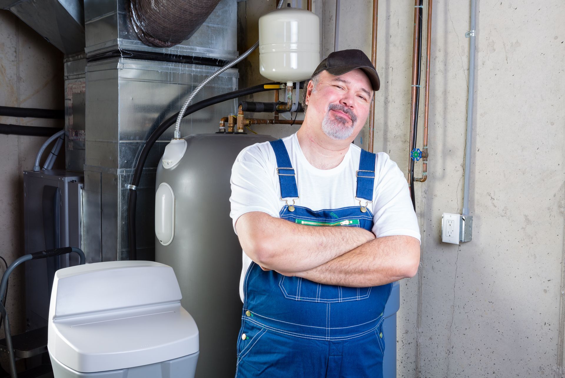 the plumber smiles at the camera having completed his task, the home now has a water softener protecting the home's water from harsh buildup and mineral deposits