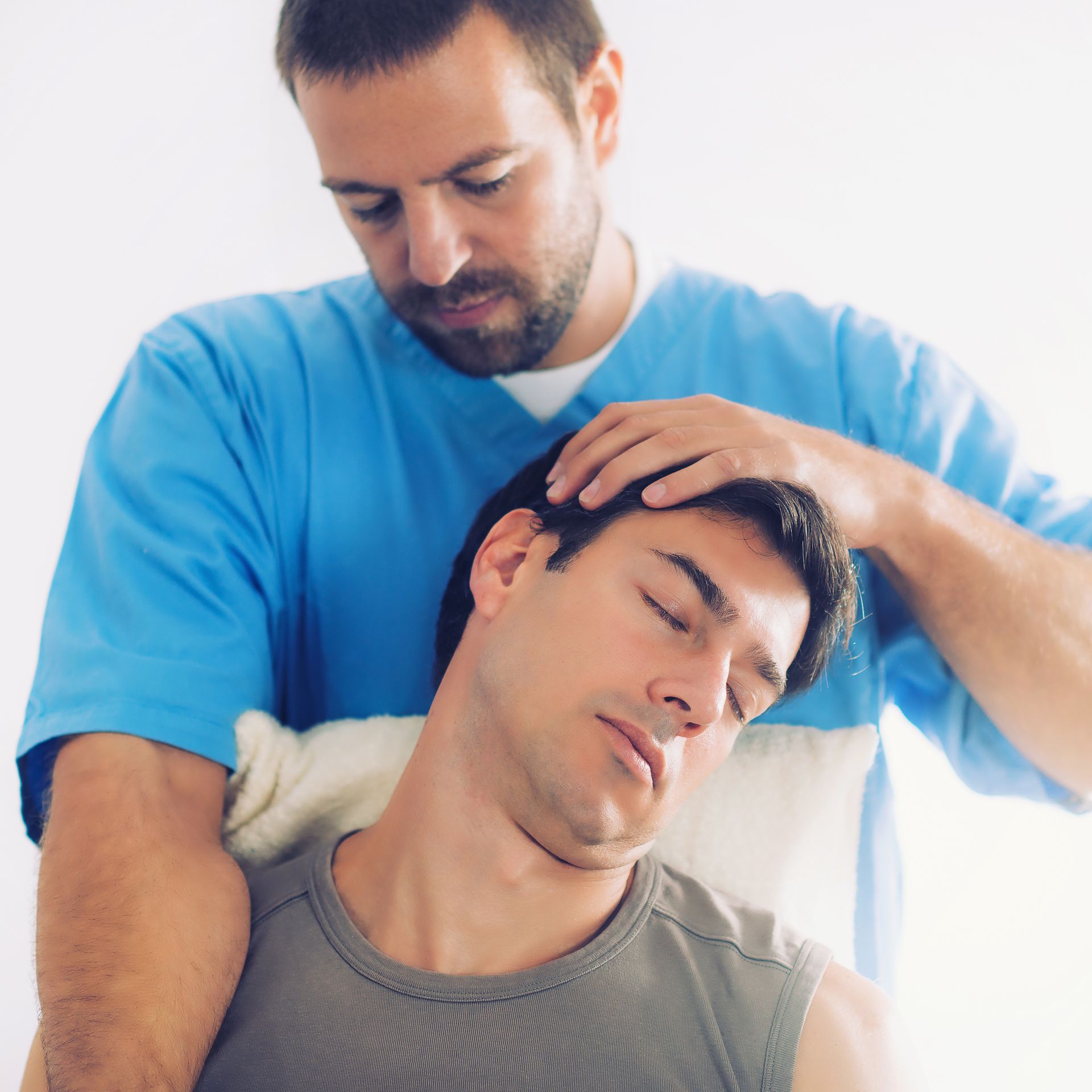 a man gets a neck adjustment from a chiropractor after a workout