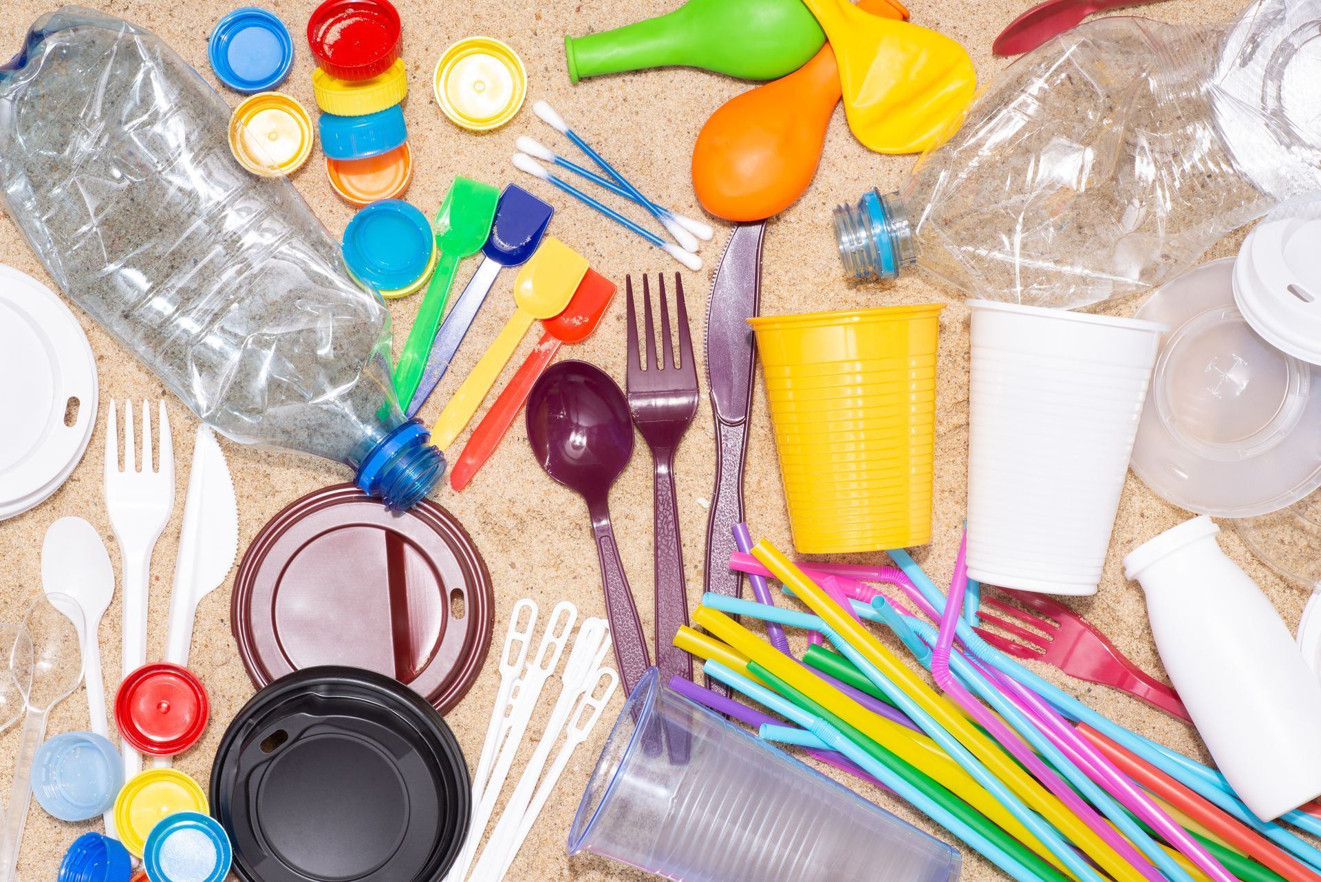 there are many different types of plastic utensils on the table .