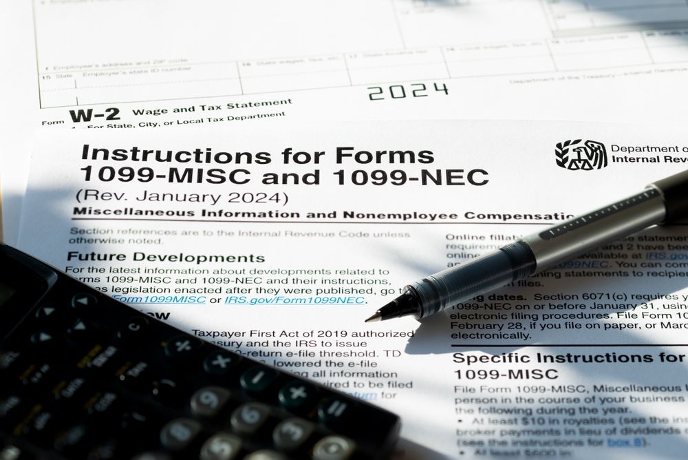 A pen is sitting on top of a form that says instructions for forms 1099-misc and 1099-nec