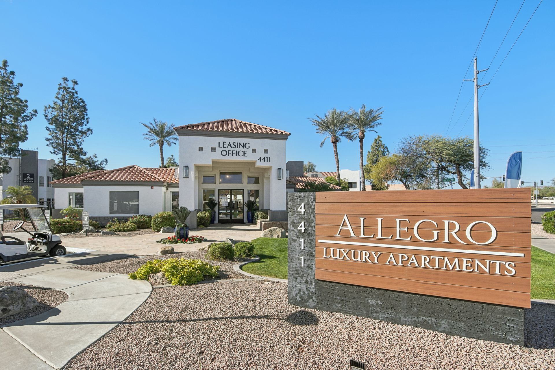 Allegro Luxury Apartments sign and entrance on a sunny day.