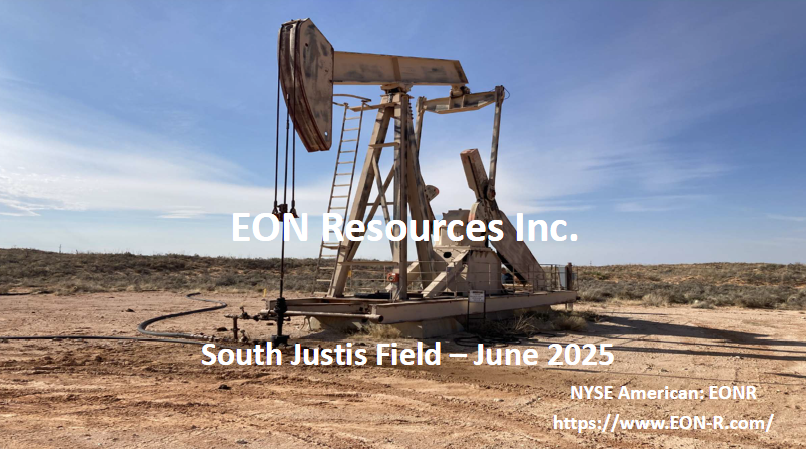 An oil pump is sitting in the middle of a desert.