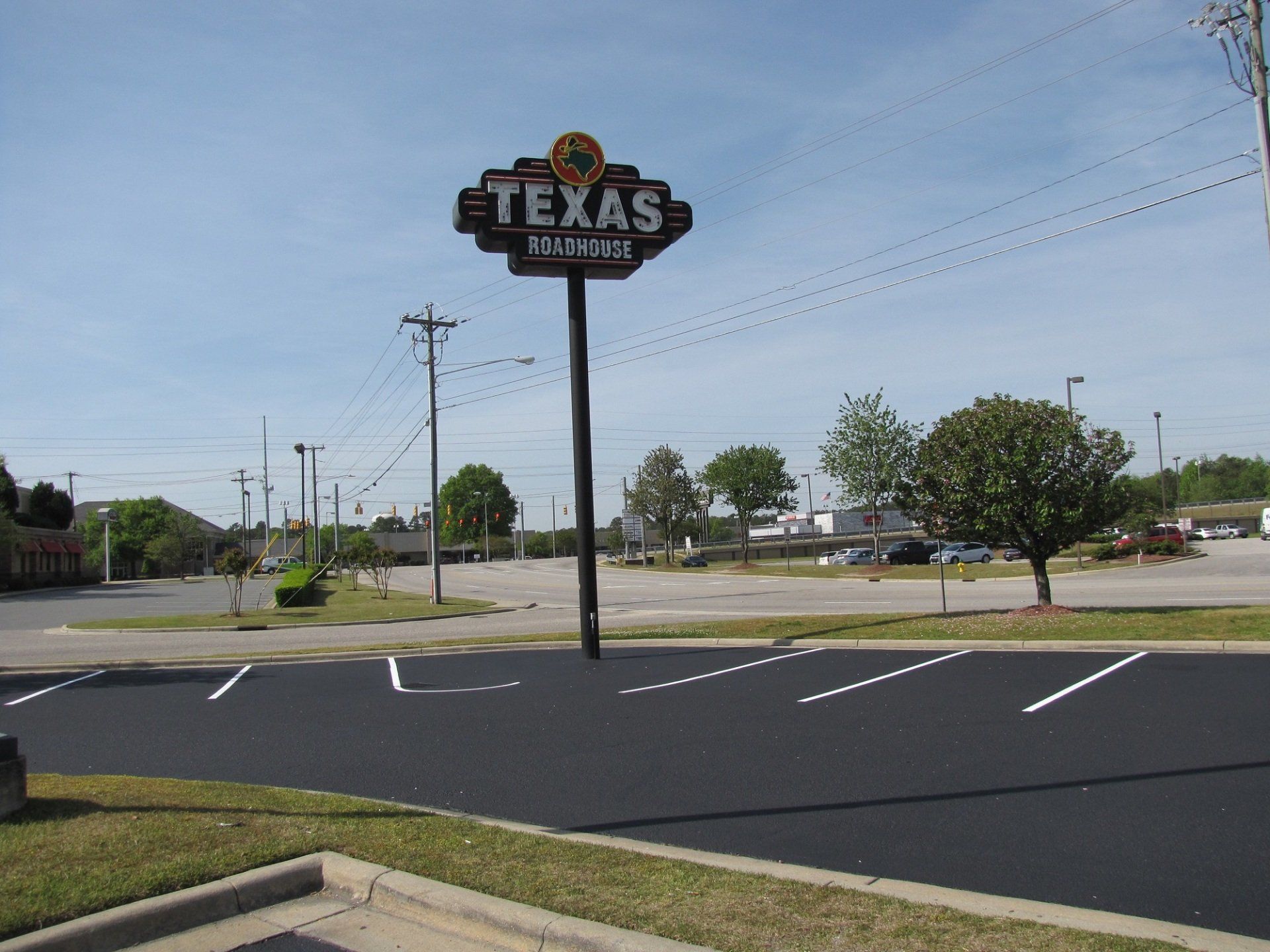A large texas sign is in the middle of a parking lot