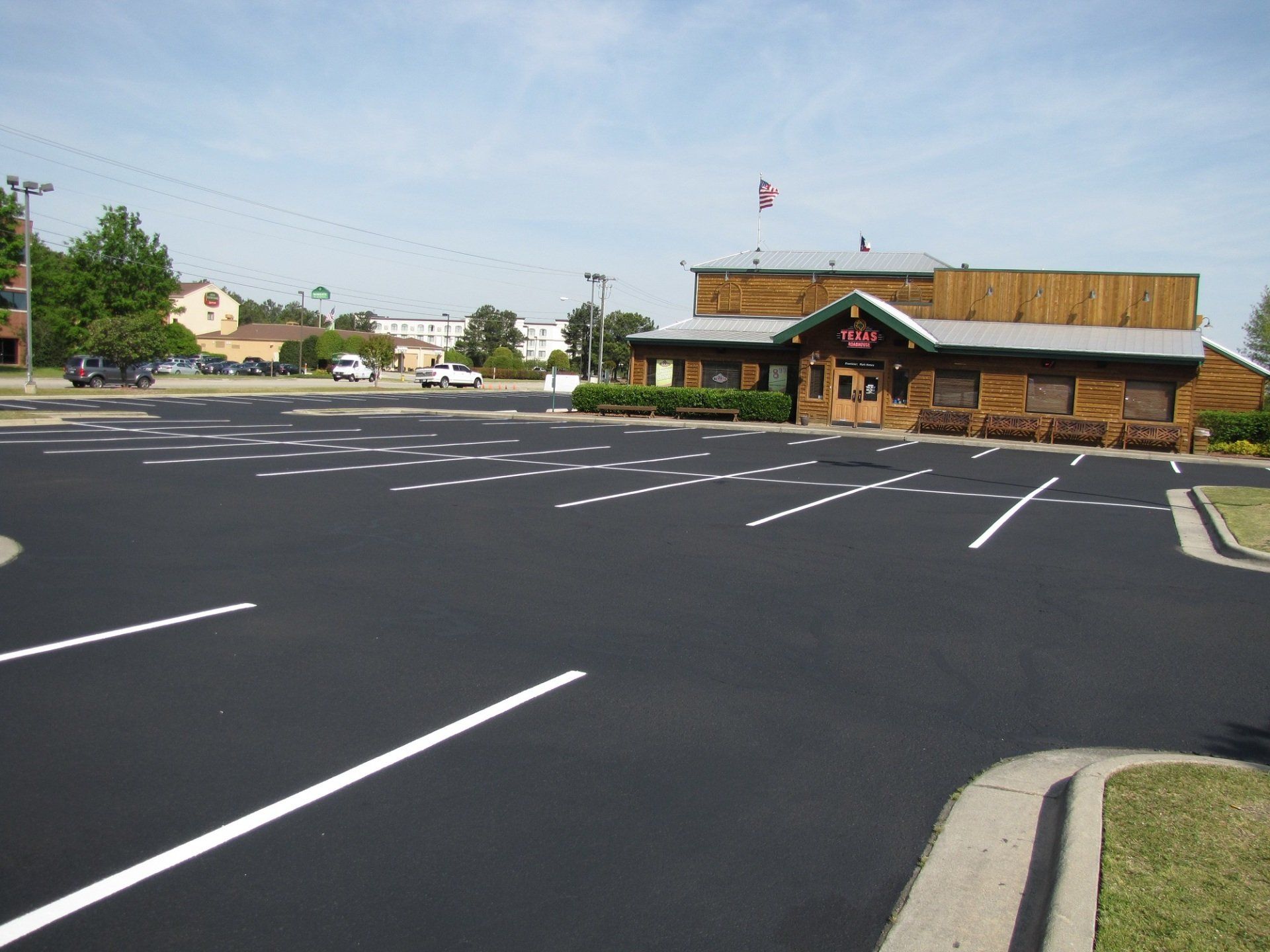 A parking lot with a restaurant in the background