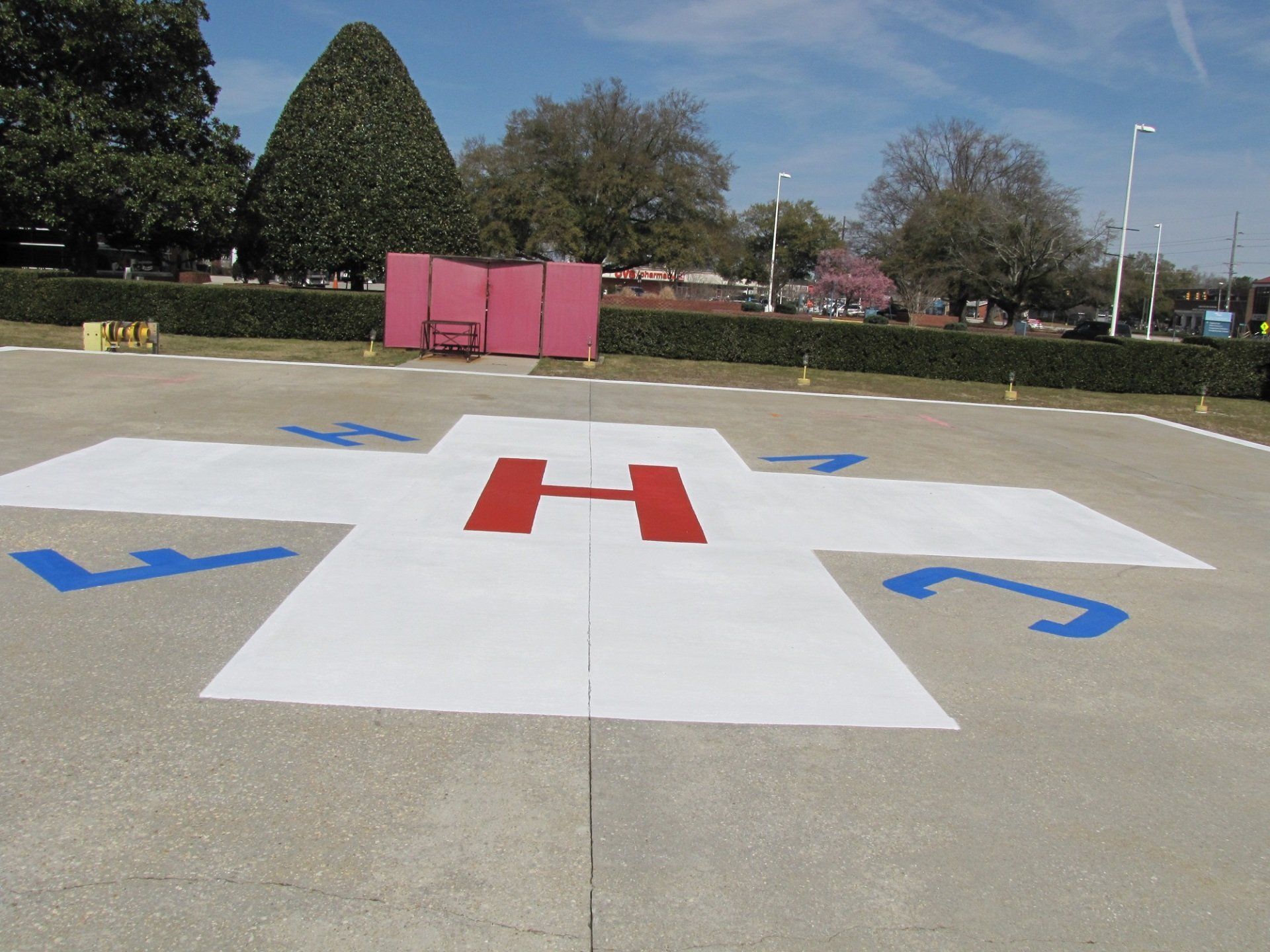 A white cross with the letter h painted on it