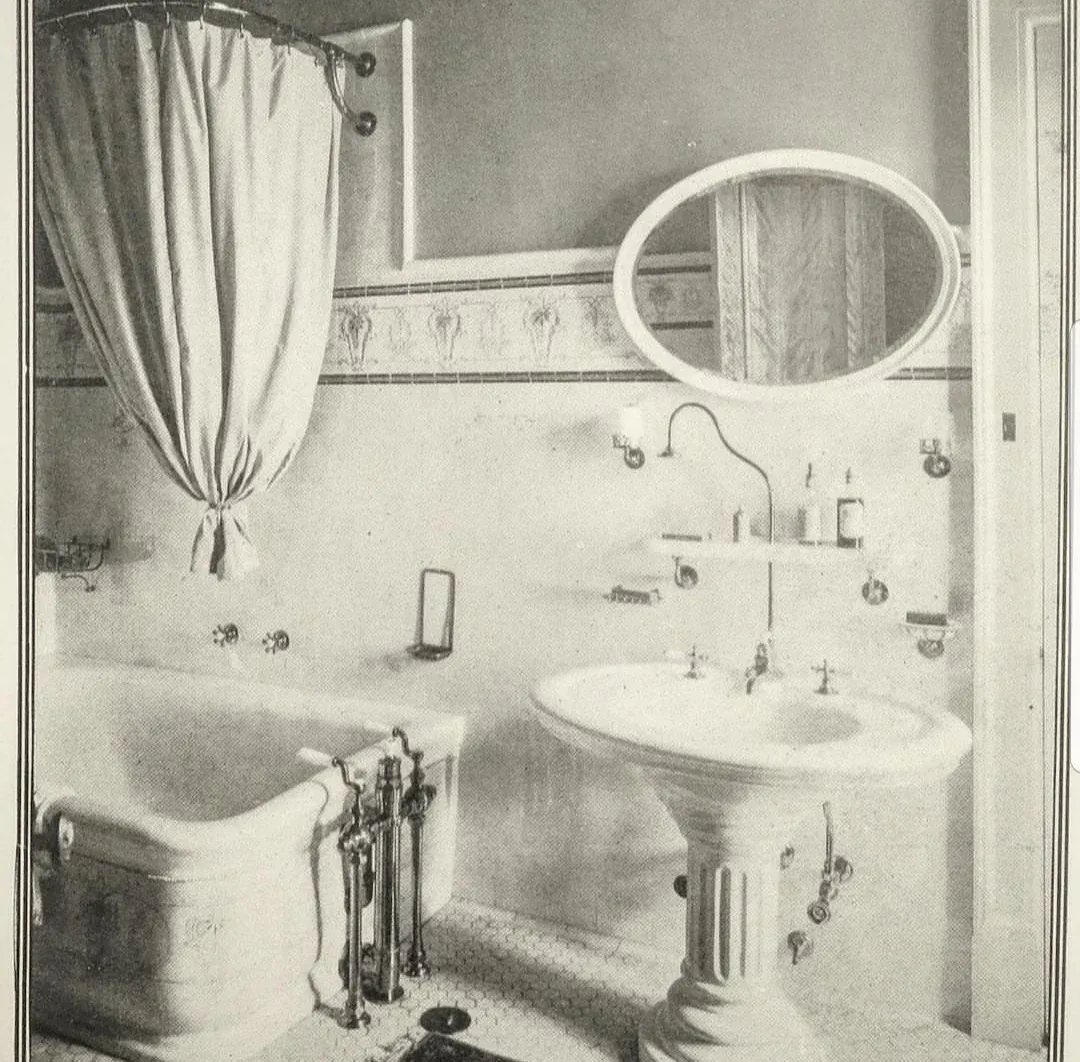 A black and white photo of a bathroom with a bathtub sink and mirror