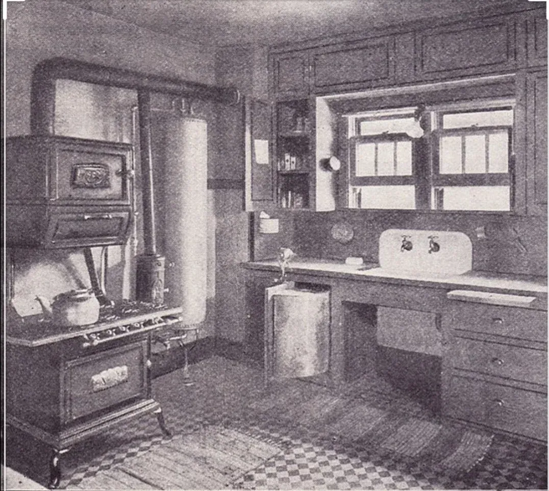 A black and white photo of an old kitchen