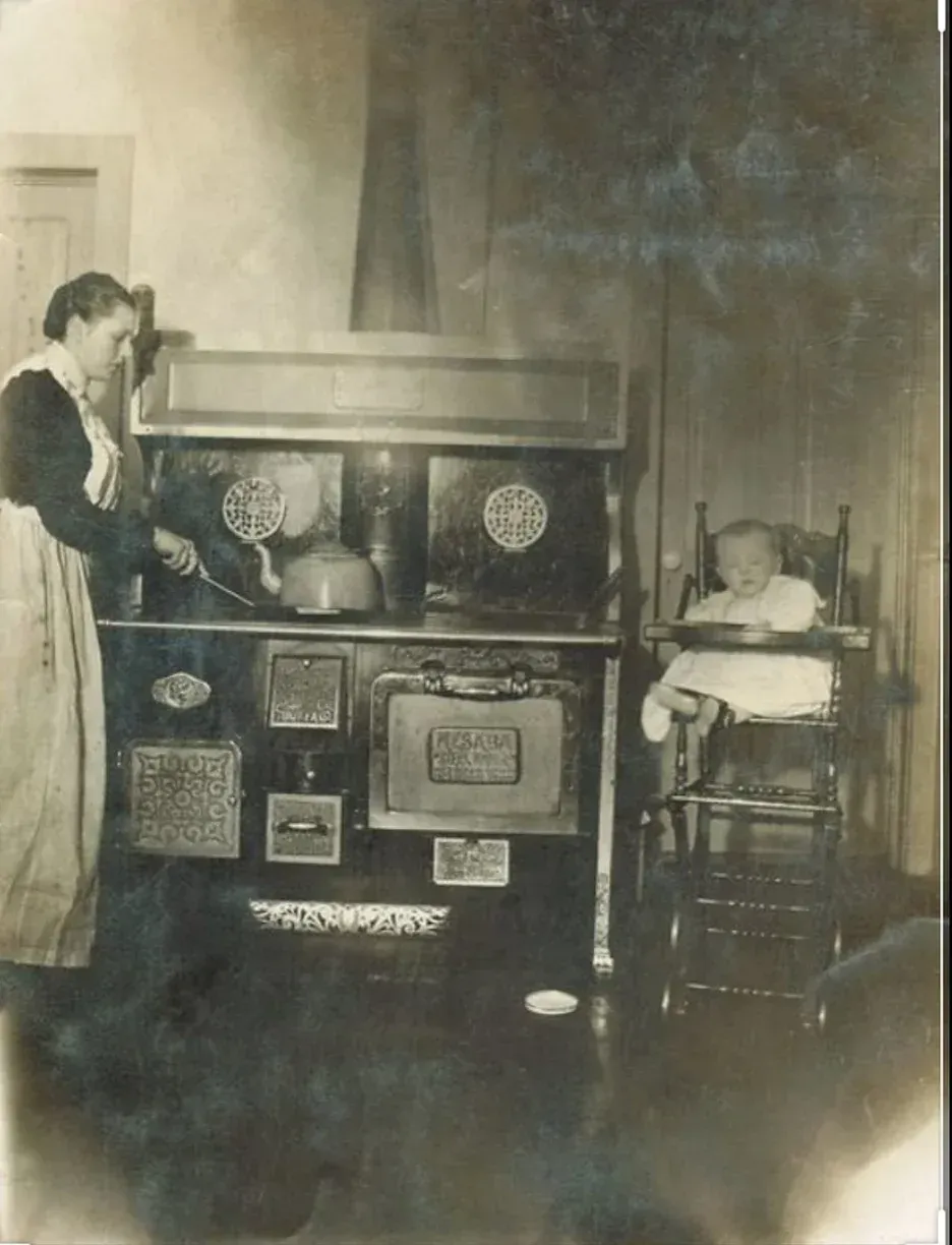 A black and white photo of a woman and a baby