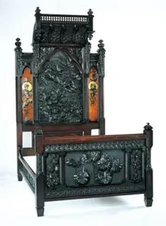 A bed with a gothic design on it