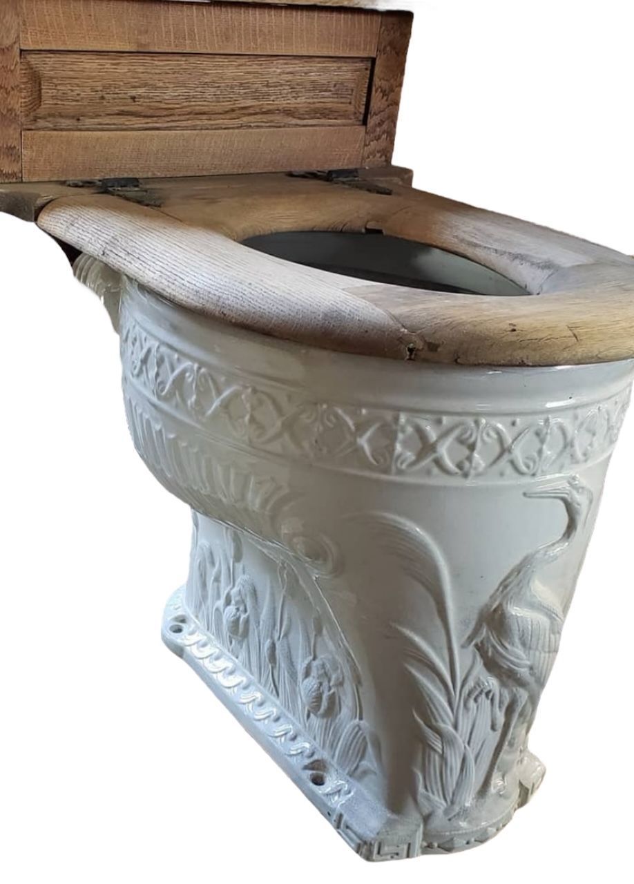 A white toilet with a fancy design on it