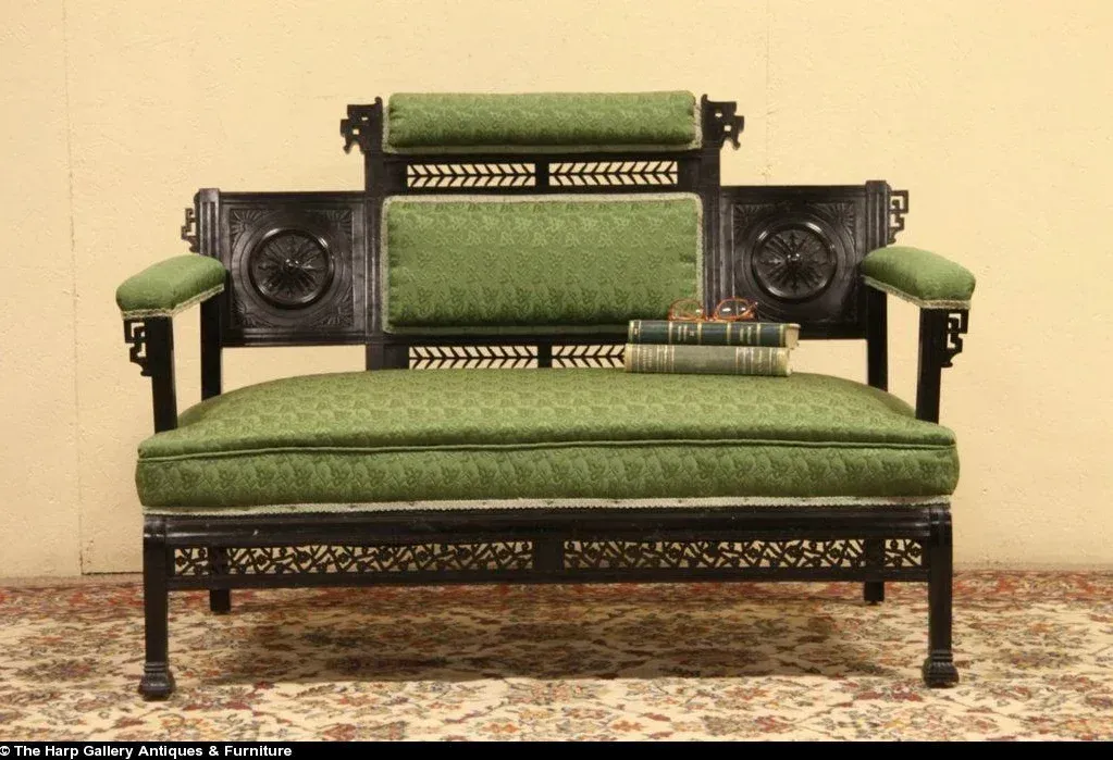 A green and black couch is sitting on a rug