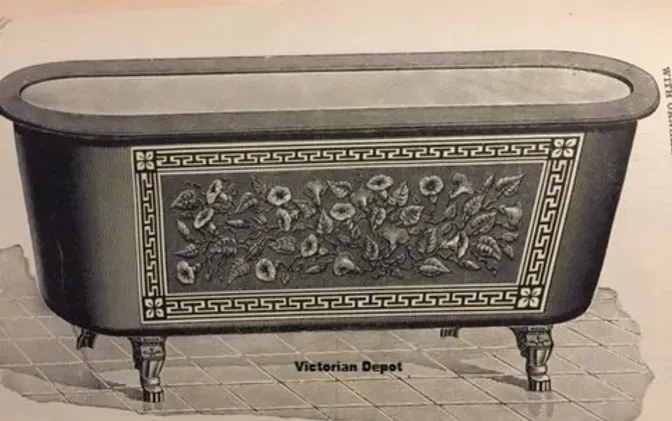 A black and white drawing of a bathtub with flowers on it.