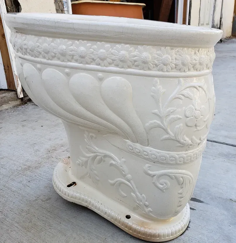 A white toilet with a floral design on it