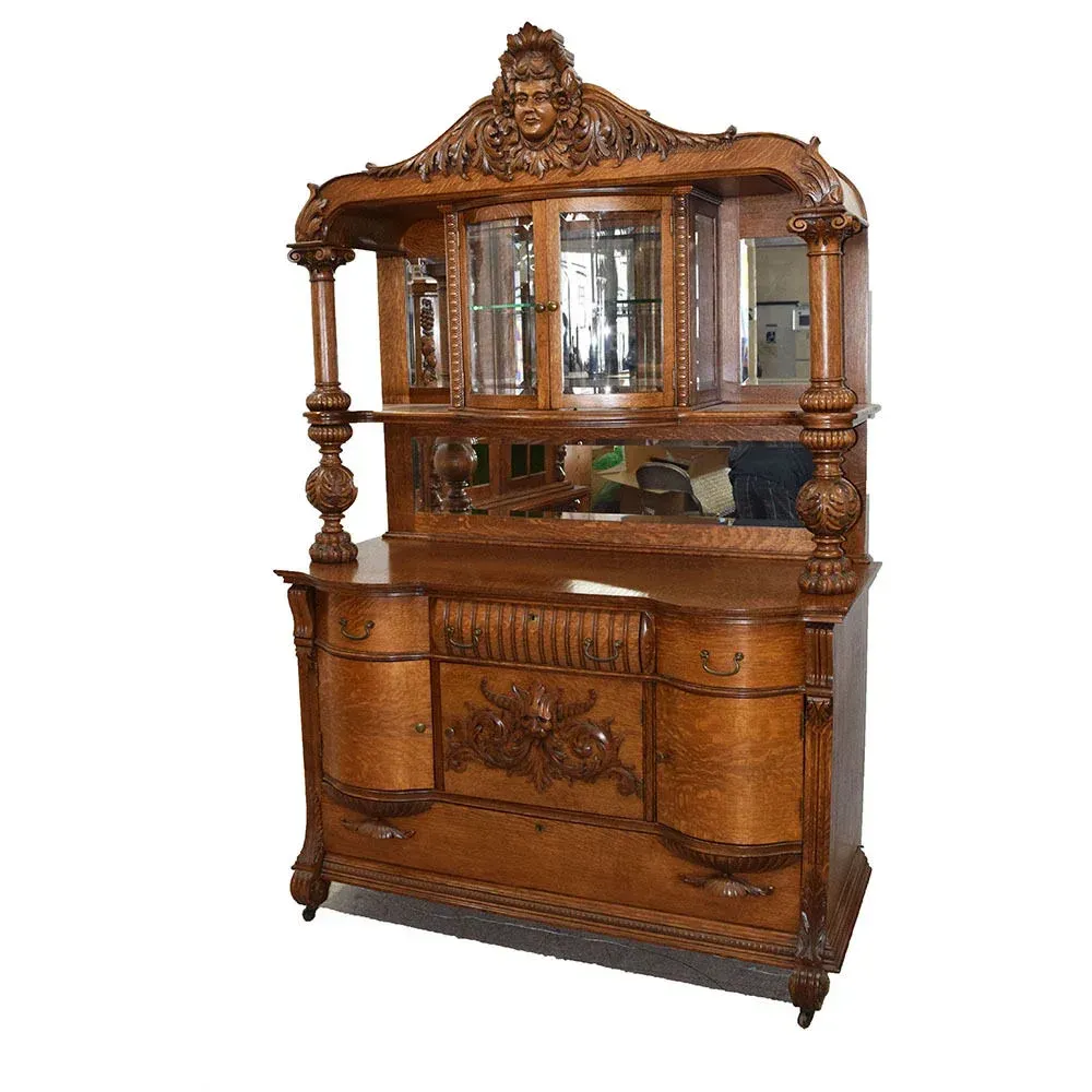 A large wooden cabinet with a mirror on top
