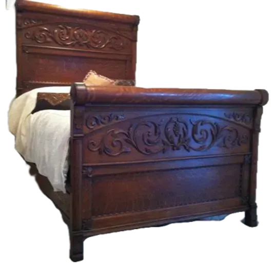 A wooden bed with a white comforter on it