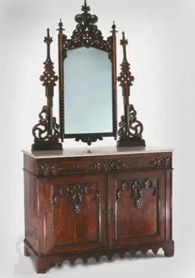 A wooden cabinet with a mirror on top of it