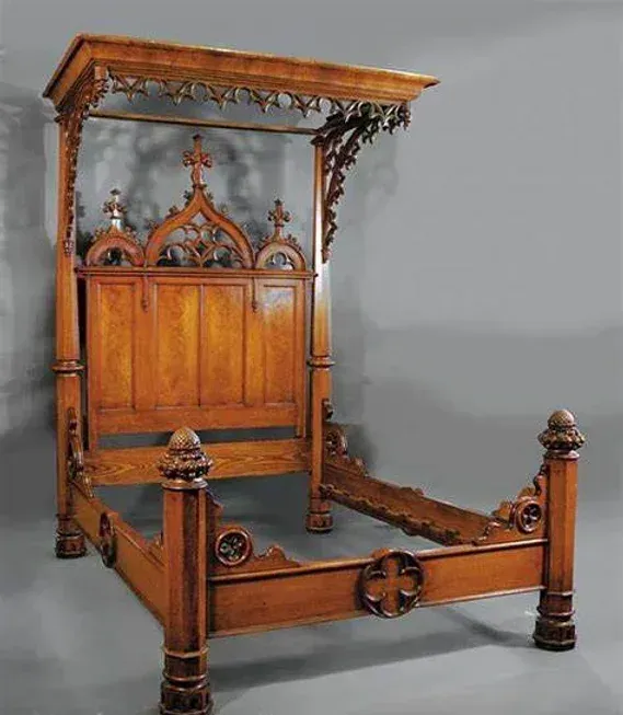 A wooden canopy bed with a cross on the headboard