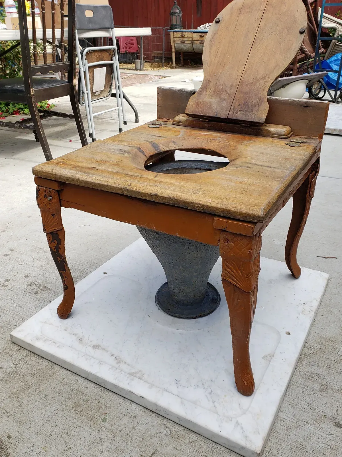 A wooden chair with a hole in the middle of it