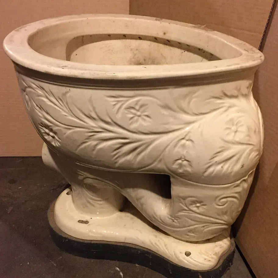 A white toilet with a floral design on it