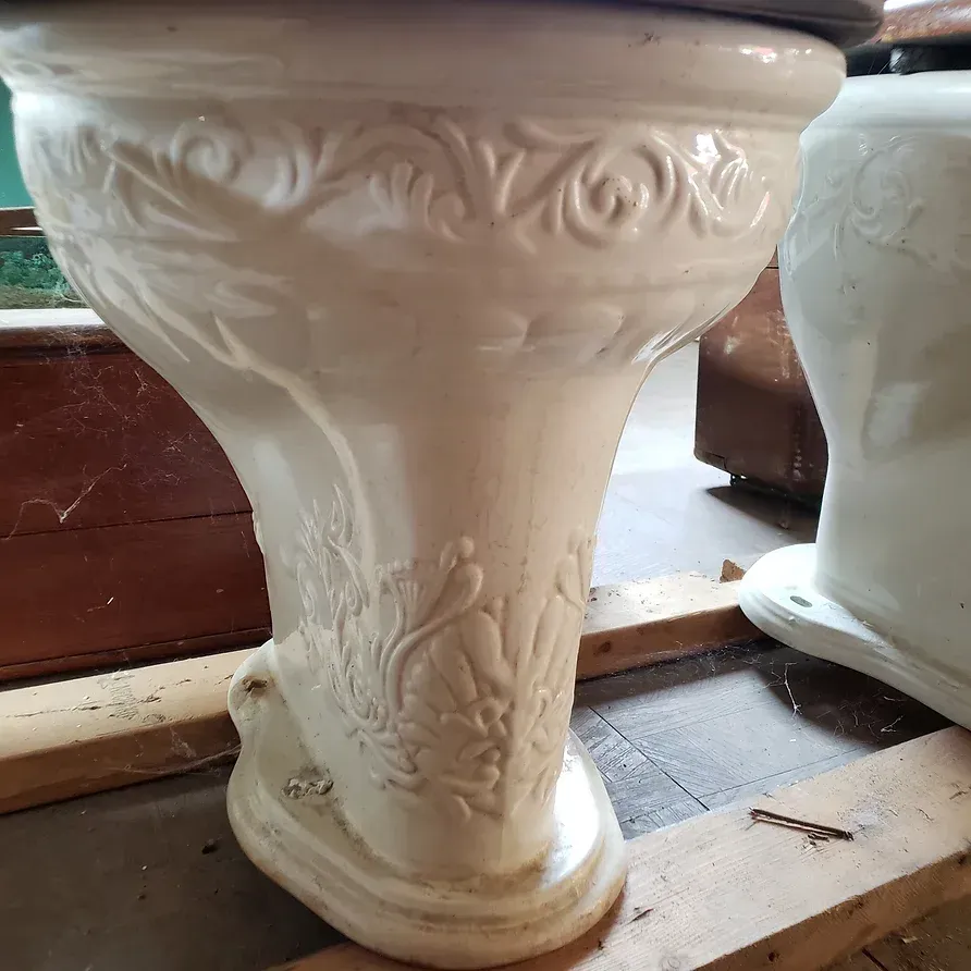 A white toilet with a floral design on it