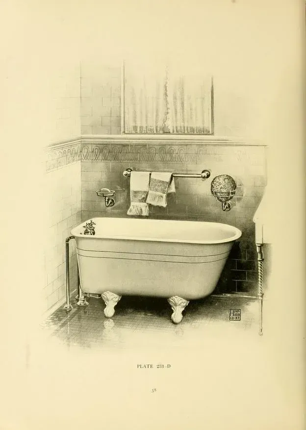 A black and white photo of a bathtub in a bathroom.