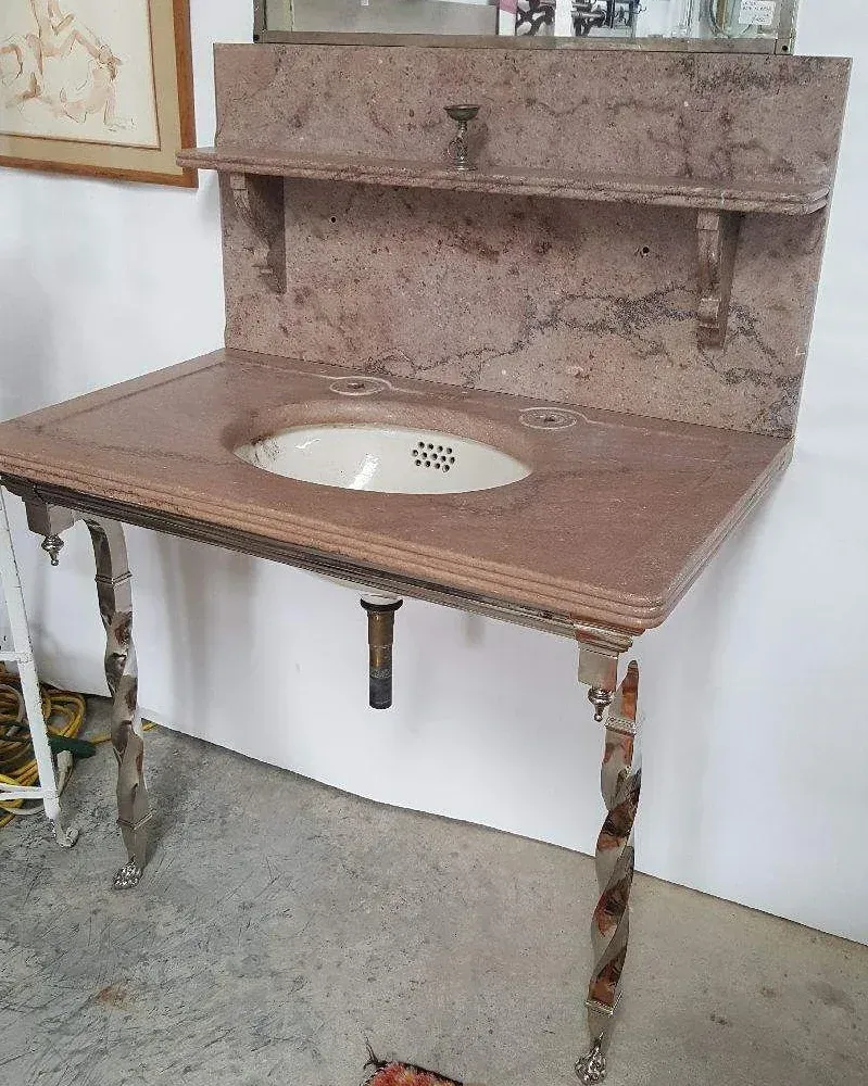 A marble counter top with a sink underneath it