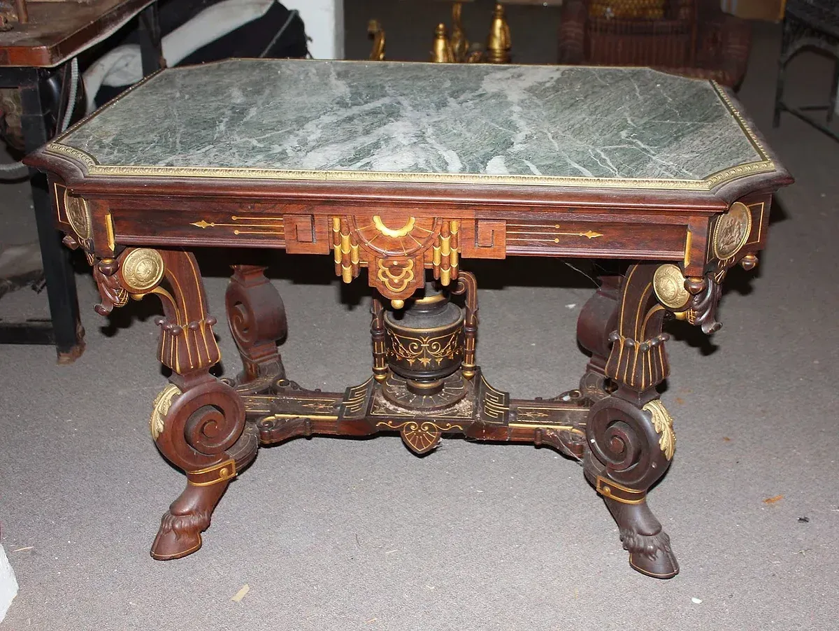 A wooden table with a green marble top