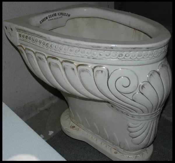 A white toilet with the word edwin written on it