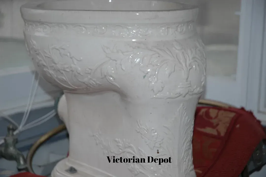 A white toilet sits in front of a sign that says victorian depot