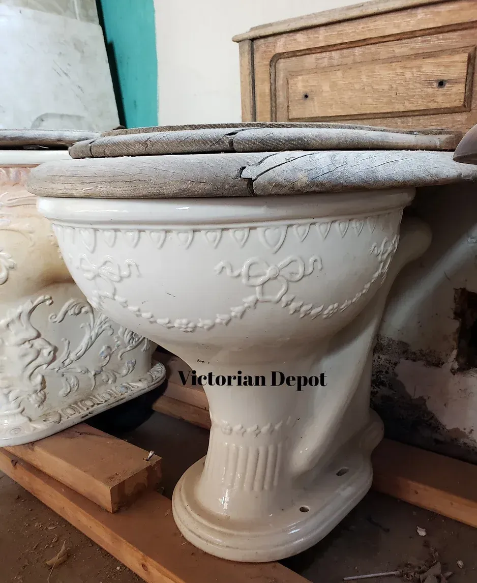 A victorian depot toilet sits on a wooden shelf