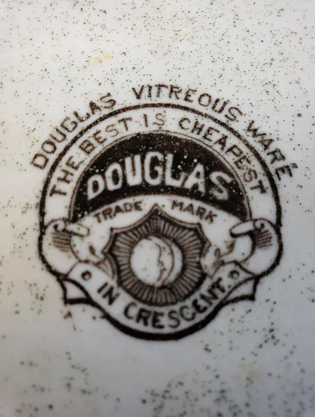 A sign that says douglas vitreous ware the best is cheapest