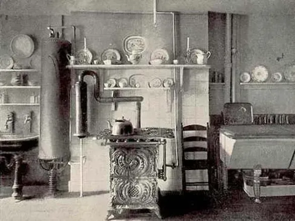 A black and white photo of a kitchen with a stove and a sink.