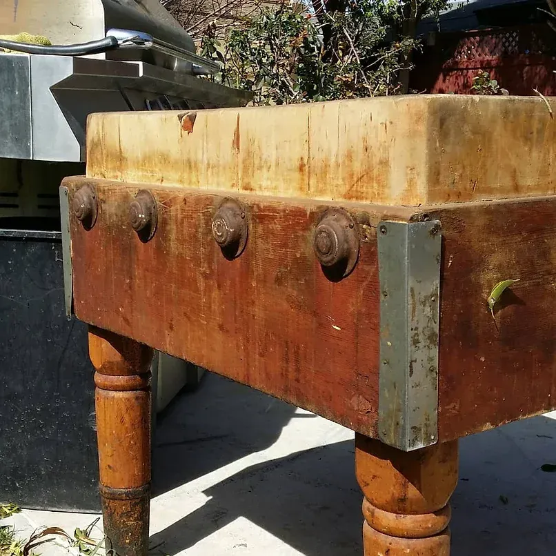 A wooden table with a large piece of wood on top