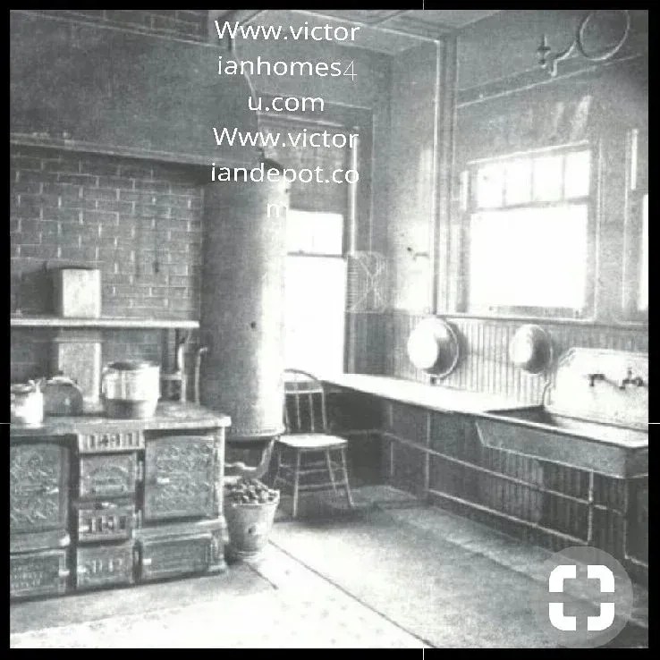 A black and white photo of a kitchen with the website www.victor lanhomes.com