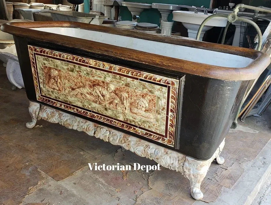 A bathtub with a tapestry on the side is in the victorian depot