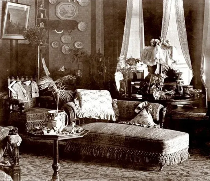 A black and white photo of a living room with furniture