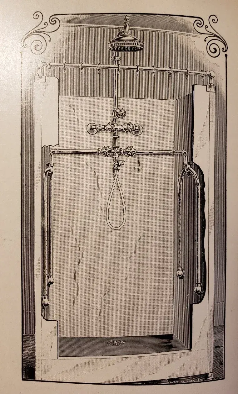 A black and white photo of a shower with a cross on it