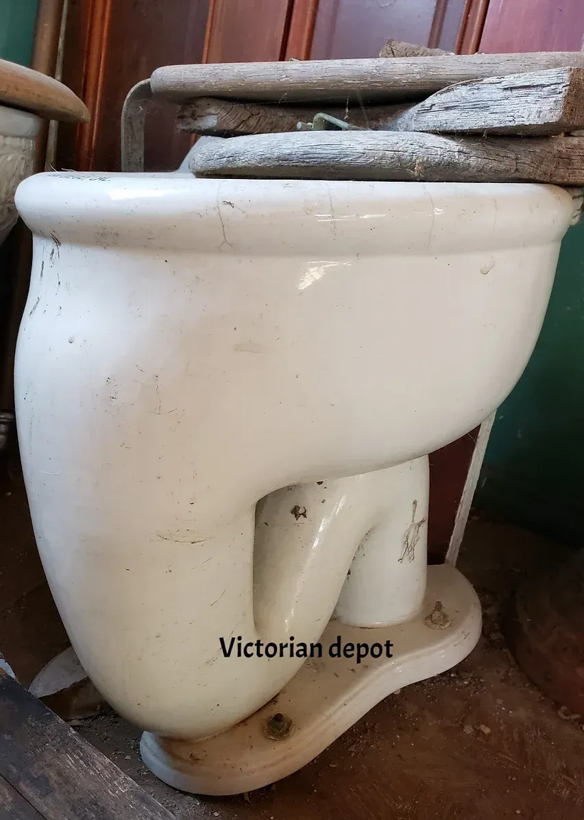 A white toilet with the words victorian depot on the bottom