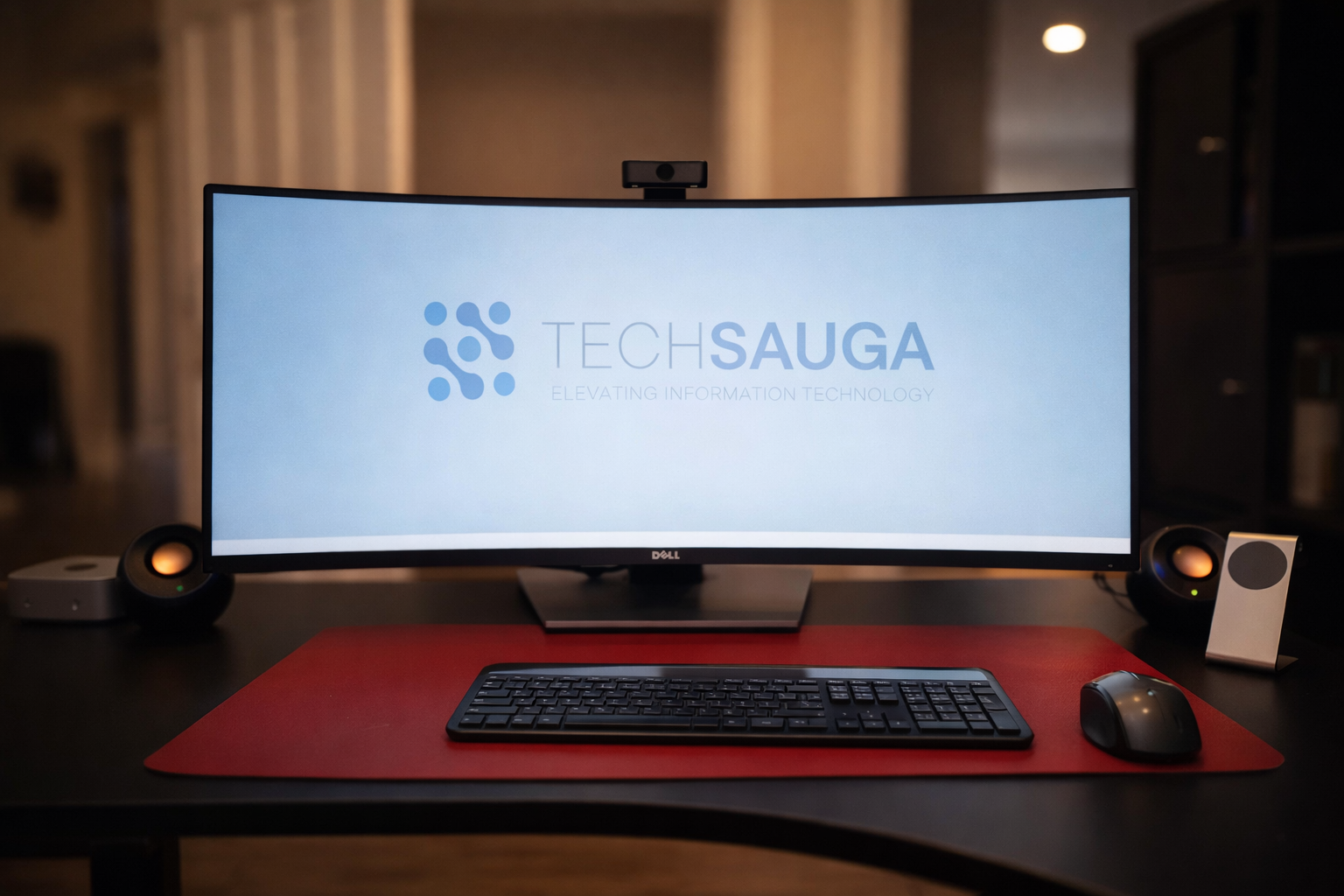 Man in suit working on server equipment, holding tablet. Blue and orange cables in server room.