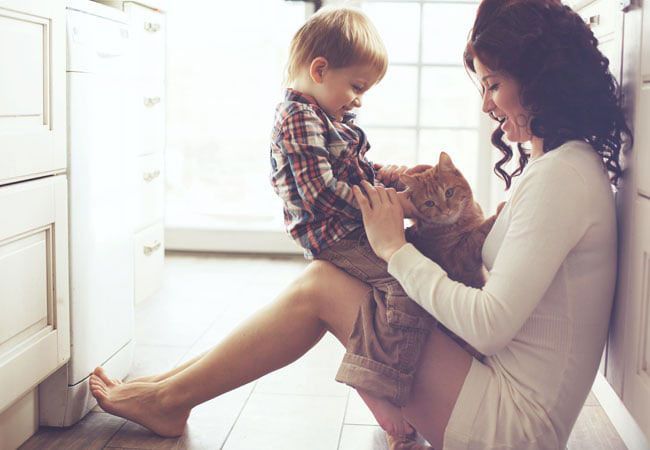 mother and son holding a kitten