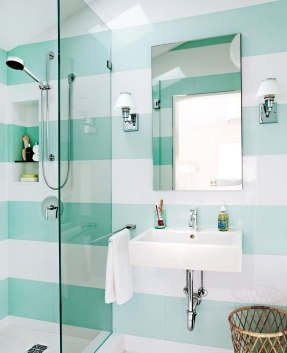 A bathroom with striped walls and a sink
