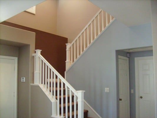 A staircase in a house with a white railing