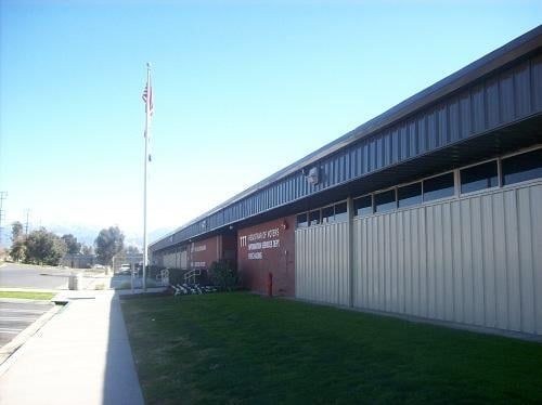 A large building with a flag pole in front of it.